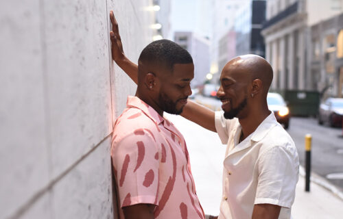 USA, Louisiana, Smiling gay couple flirting in city