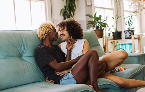 Beautiful gay couple being romantic indoors